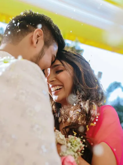It's the small, in-between moments that tell the biggest stories. This close-up captures the uninhibited laughter and deep connection between the couple during their Haldi ceremony.