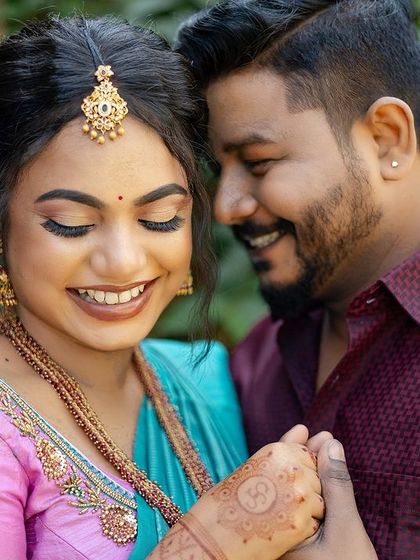 A close-up of Sugirtha and her groom, capturing their happy smiles. Her engagement makeup features a perfectly blended eyeshadow and a lip colour that complements her vibrant saree.
