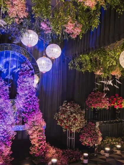 A detailed shot of the decor elements within the enchanted forest theme. You can see the combination of purple and red flowers, the circular mirror accent, and the layered lighting effects.
