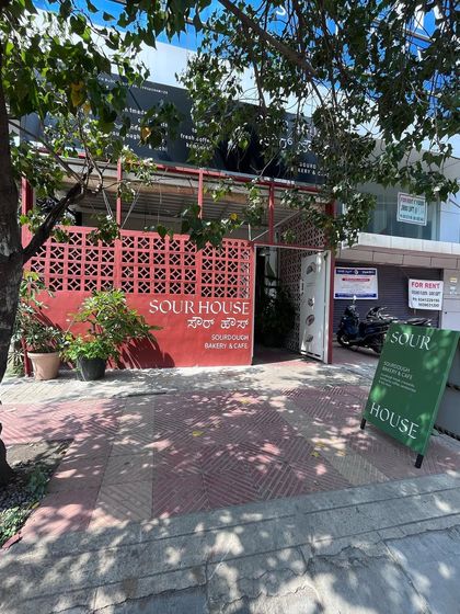 The full entrance of the bakery, showing how the wall art is a central part of its street-side appeal.