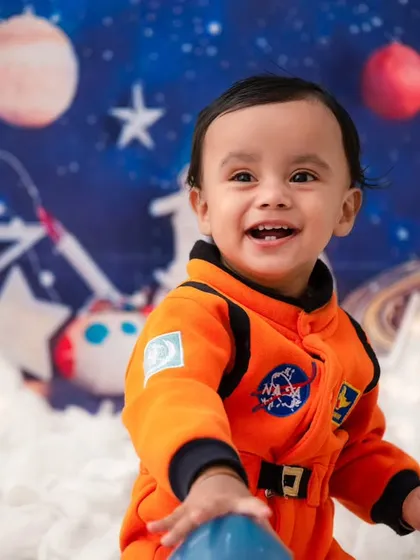 To the moon and back! My studio is equipped for imaginative adventures, like this astronaut theme. I provide all the props and costumes to bring your child's biggest dreams to life in a creative photoshoot.