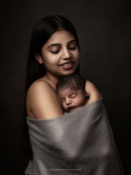 The color version of this embrace, with a dark, moody background that creates a painterly, fine-art feel.