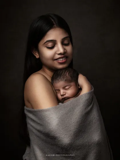 The same loving embrace, this time in warm, painterly color. It shows the soft skin tones and the peaceful connection between mother and child.
