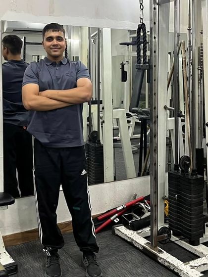 Arms crossed, confident pose.