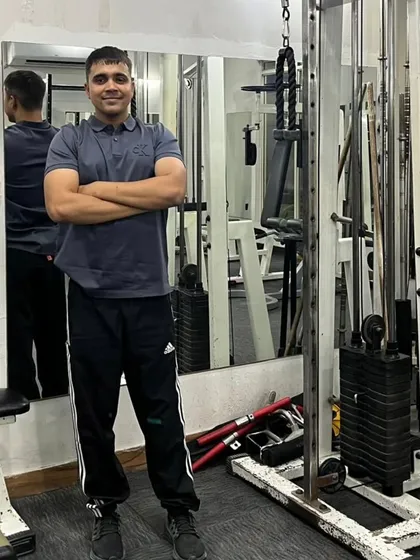 Arms crossed, confident pose.