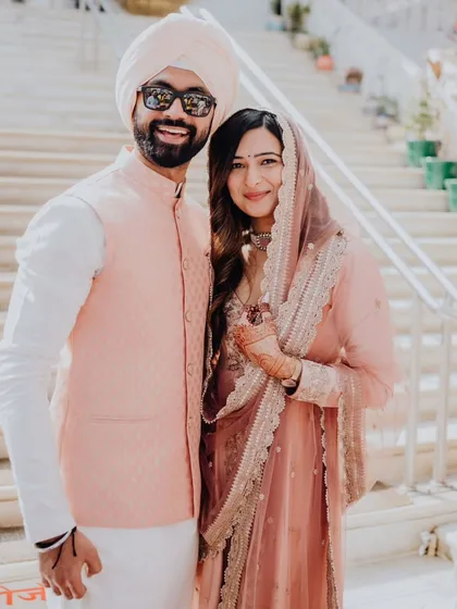 A happy, relaxed portrait of the couple in their coordinated pastel outfits for their engagement.