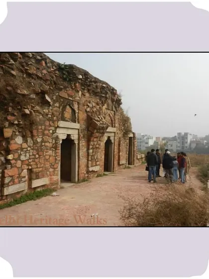 Walking along the base of the Bijay Mandal ruins, with the modern city visible in the background. This juxtaposition of past and present is a constant theme in our explorations of Delhi.