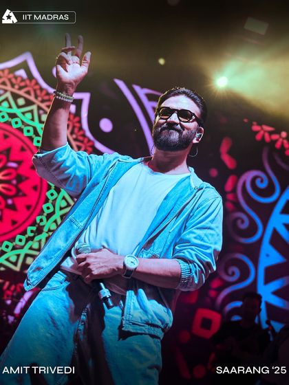 Amit Trivedi in his element at Saarang '25, IIT Madras. The vibrant, colorful visuals on the screen behind him were part of our custom AV package.