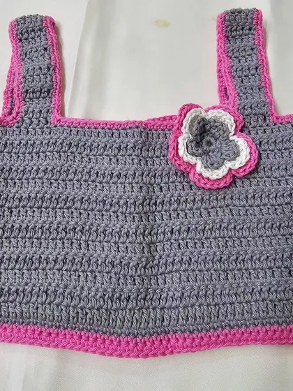 A closer look at the top from the 'Lil Pink Coord Set,' showing the flower embellishment. It's a sweet detail that adds a touch of charm.