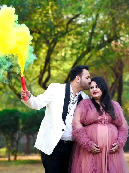 Let's add a pop of color! Using a smoke bomb during an outdoor couple shoot creates a dynamic and celebratory atmosphere, making your photos fun and memorable.