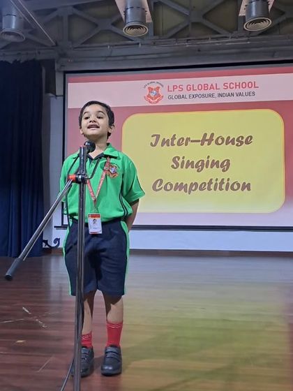 A young student from Class I confidently performs a solo at the Inter-House Singing Competition. We encourage participation from the earliest grades to build stage confidence.