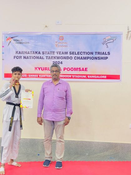 A black belt student with his gold medal at the state selection trials. Reaching this level requires immense dedication to the art of Taekwondo.