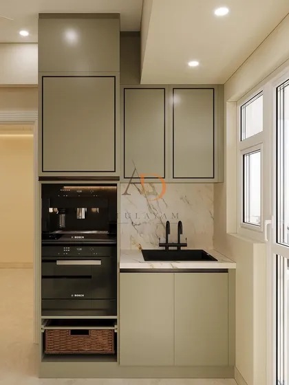 This compact kitchen utility area features a built-in coffee machine and oven, showcasing smart use of vertical space. The design maintains the home's aesthetic with matching cabinetry and a marble backsplash, proving no corner is too small for functional luxury.