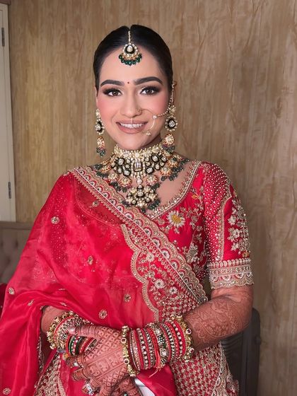 A classic bridal portrait. The makeup is perfectly balanced, with attention to the eyes, lips, and skin to create a look of pure elegance.