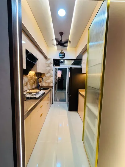 This long shot of the galley kitchen shows the efficient layout, with the sink and stove on one side and extra counter space on the other.