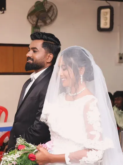 A candid moment of a bride and groom during their Christian wedding ceremony. Her makeup looks flawless and natural.