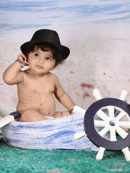 Explore our full nautical and beach-themed collection. These images showcase the variety of poses and angles possible with our boat prop, sand-colored flooring, and ocean backdrop.