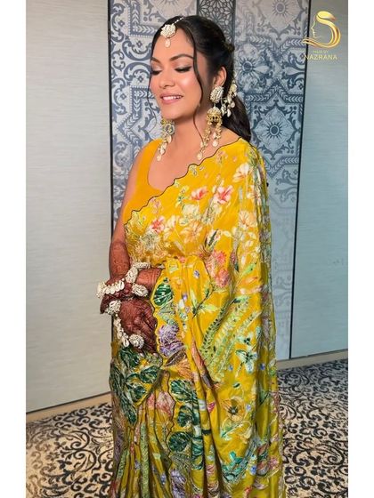 My bride looking radiant in her yellow saree, with a hairstyle that's all about love.