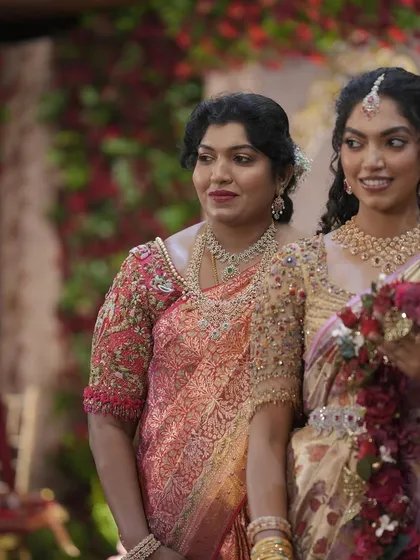 A candid moment between the bride and her family member, both wearing custom Needle Eye creations. It shows how I coordinate outfits to create a harmonious look for the entire wedding party.