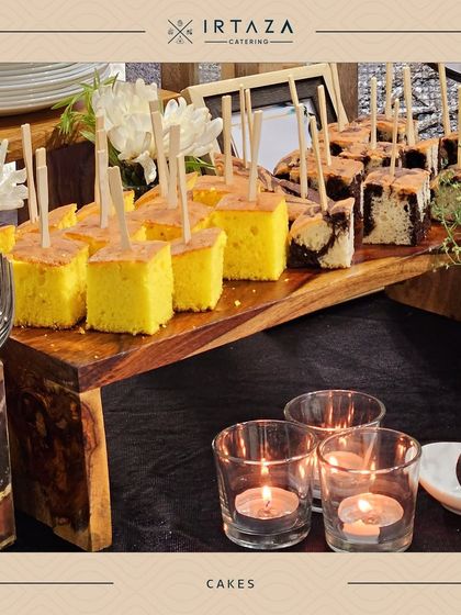 Bite-sized pieces of marble cake and pound cake served on a rustic wooden board, perfect for guests to enjoy with coffee or tea.