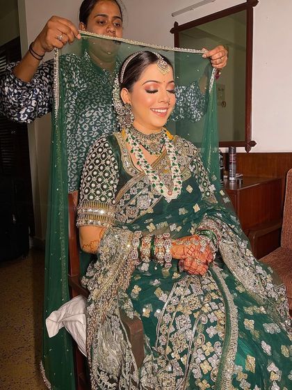 I love capturing these final moments. Here, I'm helping the bride with her dupatta over the traditional bun I styled for her wedding day.