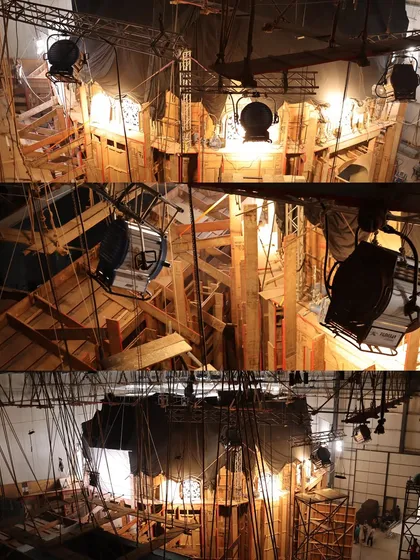 The back of the 'Chhaava' set, revealing the raw wooden structures and the lighting fixtures positioned to create the authentic, warm look of the period film.