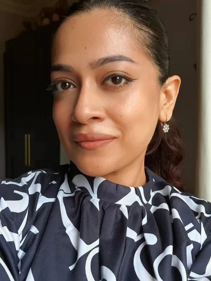 A polished look with hair pulled back, showcasing a sharp but subtle winged liner and glowing skin. This demonstrates how a few key details can create a very put-together appearance.