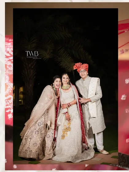 A fun family portrait from the wedding day. The bride and groom share a laugh with a family member, capturing the relaxed and happy atmosphere of the celebration.