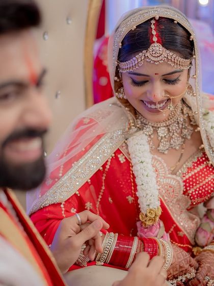 A happy moment during the ring ceremony, showcasing her beautiful smile and flawless makeup.