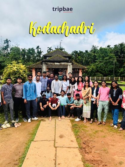 The group posing in front of a traditional house that serves as a homestay during the Kodachadri trek.