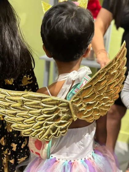 An angel in the house! A beautiful shot of the back of a unicorn-angel costume with golden wings.