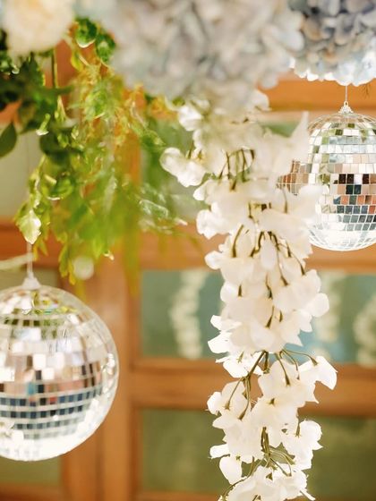 Another detail shot of our disco-themed Sangeet decor. The reflective surfaces of the disco balls catch the light beautifully, adding a touch of sparkle and fun to the floral arrangements.