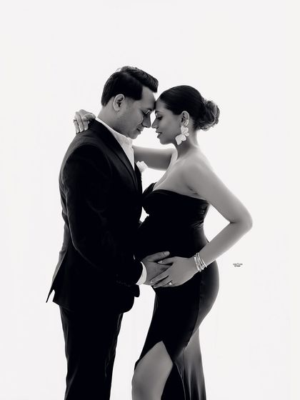 A beautiful, intimate black and white moment. This close-up shot focuses on the tender connection as they anticipate their baby's arrival.