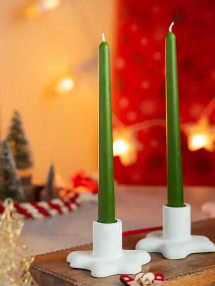 I also make these unique star-shaped stands for my tapered candles. Here they are in white, holding a pair of green candles.