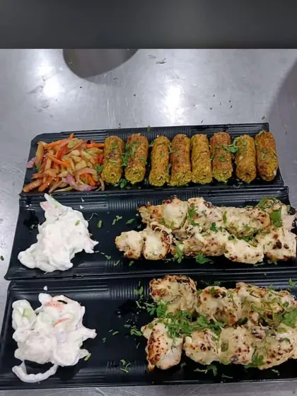 A platter of our freshly prepared appetizers, featuring succulent chicken malai tikka and flavorful vegetable seekh kebabs. This is an example of the quality and presentation we bring to every corporate meal or event.