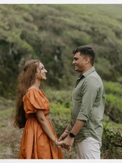 In the heart of Munnar's lush tea gardens, a simple, loving glance speaks volumes. We focus on capturing these gentle interactions that highlight the deep connection between a couple, using the vibrant green landscape as a natural frame.