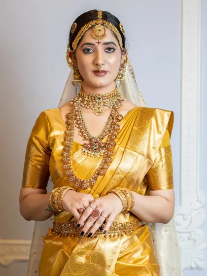 This student work shows a complete South Indian bridal look, highlighting the intricate jewellery and the flawless makeup application.