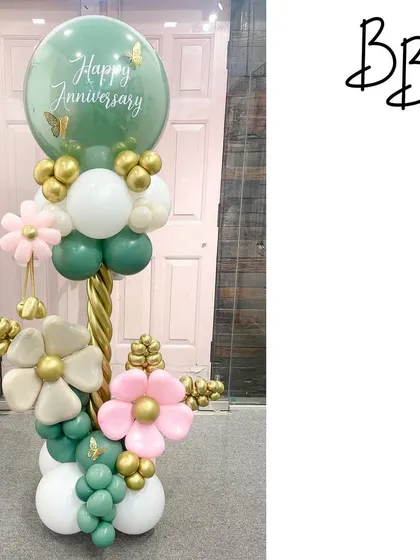 Anniversaries can be pretty, classy, and gorgeous. This elegant column in sage green, white, and gold features beautiful balloon flowers and a personalized message, creating a sophisticated celebratory piece.