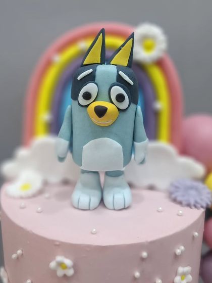 A close-up of the handcrafted Bluey figurine from the two-tier cake.