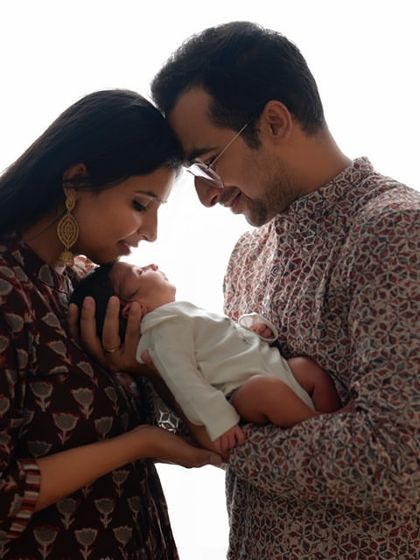 The beginning of a new family story. This backlit portrait creates a beautiful silhouette, highlighting the love and connection between new parents and their baby.