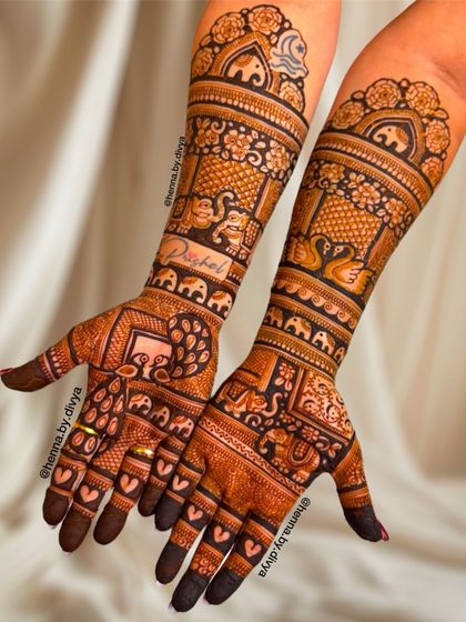 This elaborate bridal design is filled with auspicious elephant motifs. The patterns cover the hands and arms completely, creating a stunning and traditional statement.