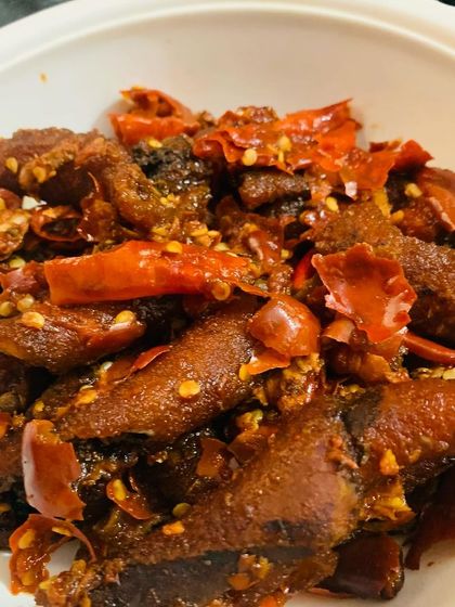 For those who like chewy textures, this is beef skin cooked with lots of red chillies and dried Sichuan pepper. The bamboo shoot water gives it a distinct Naga taste.
