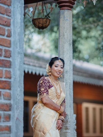 A lovely shot of the bride in a traditional setting. Her makeup is soft and natural, allowing her happy expression to be the main focus.