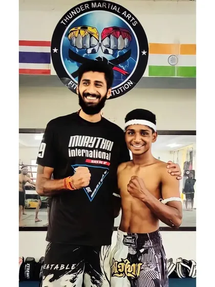 As a Kru, my role is to guide you. Here I am with one of my students after his successful grading, ready for the next level in his Muay Thai journey.
