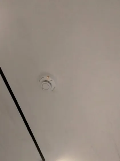 A cleanly installed smoke detector on a finished ceiling. We make sure our installations are neat and discreet, providing reliable smoke detection for homes, offices, and commercial spaces.