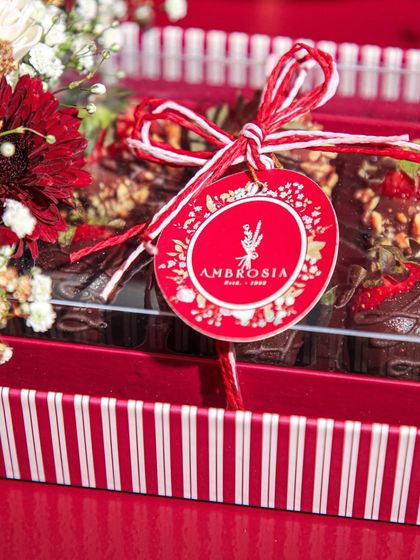 Love at first bite, and every bite after. A close-up of our Valentine's Day gift tag on a box of our signature chocolate-dipped strawberries.