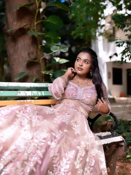 A model showcasing a glowing and radiant look in a beautiful outdoor setting.
