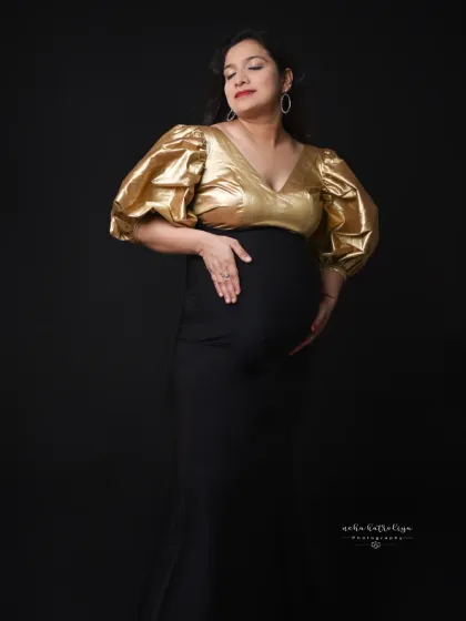 A gentle and loving pose, cradling the bump. This shows the softer side of a bold and modern maternity look.