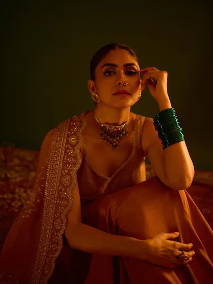 A pensive and beautiful portrait, highlighting the intricate details of the choker and nose ring.