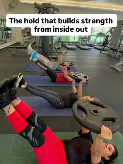 A group of my clients performing an isometric leg raise with weights. This exercise is about more than just abs; it builds a rock-solid core, strengthens hip flexors, and improves endurance for heavier lifts.